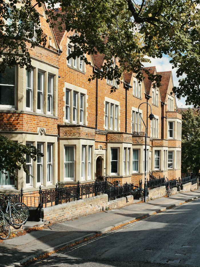 Picturesque Victorian-style row houses in Oxford, bathed in autumn sunlight.